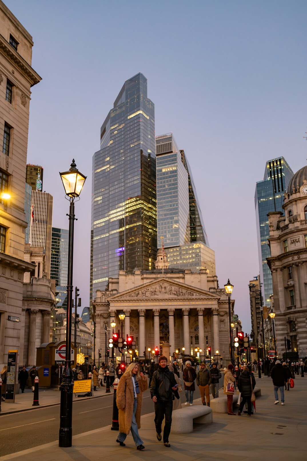 Office workers walking briskly through a financial district at rush hour
