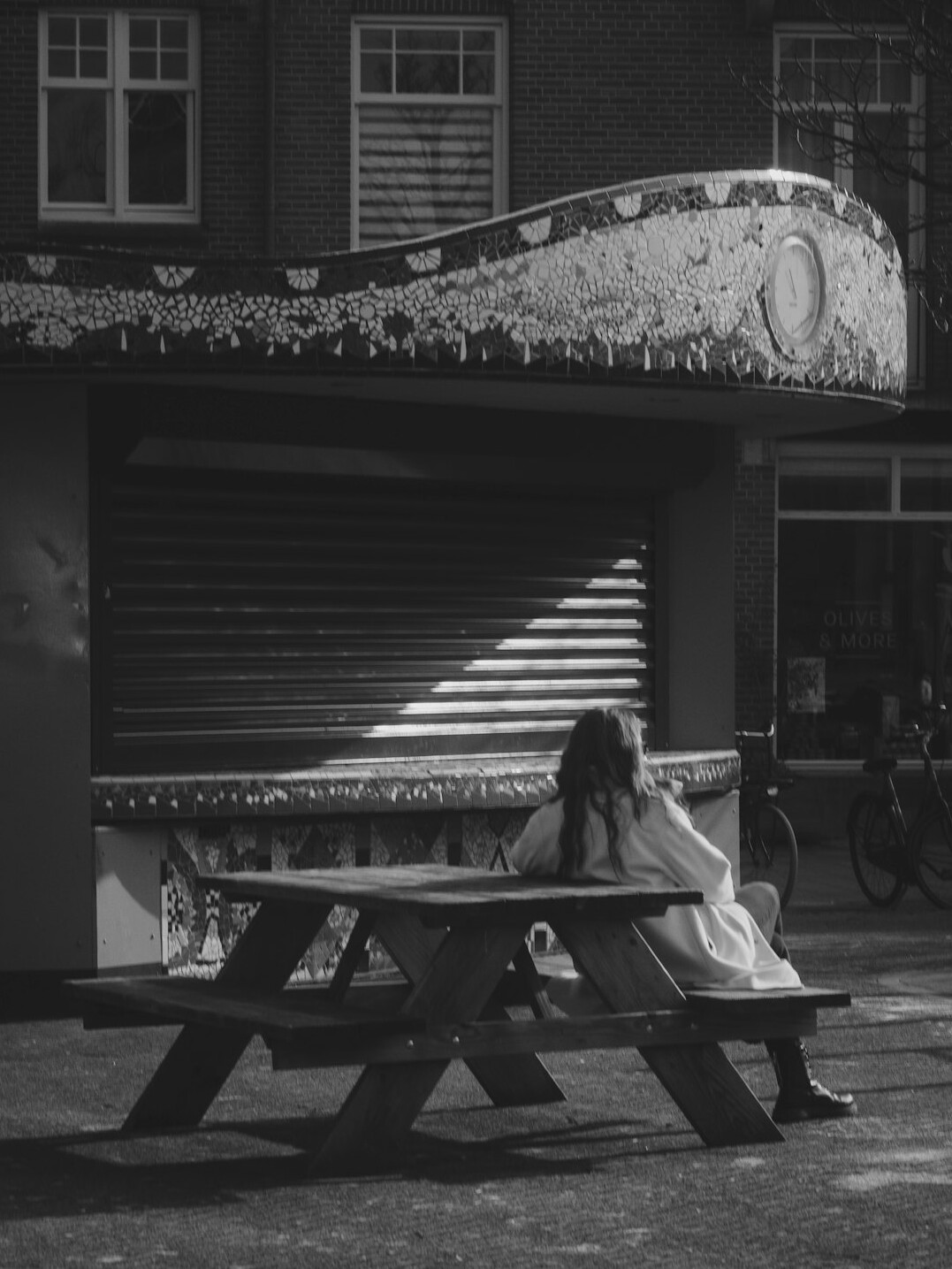 woman resting on bench at dusk
