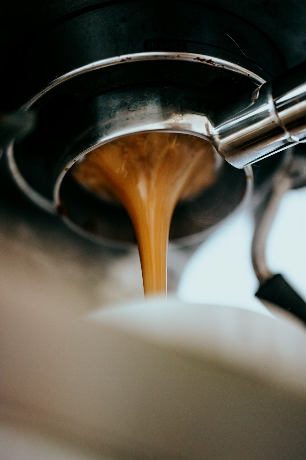 barista pouring coffee