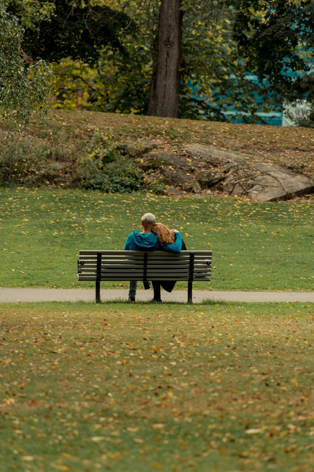 Elderly couple relaxing on a park bench in a city park